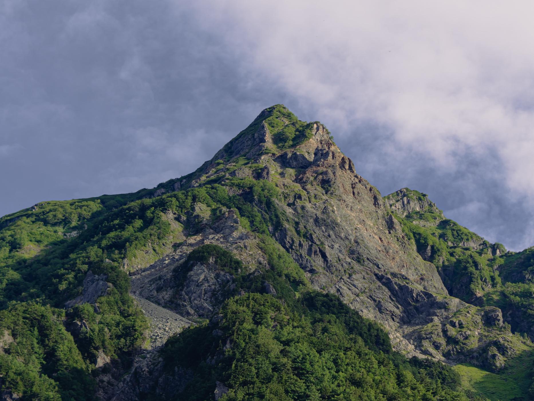 Close-up view of the dramatic rocky peak of Myojin-dake in the Japanese Alps as seen from the Kamikochi valley floor