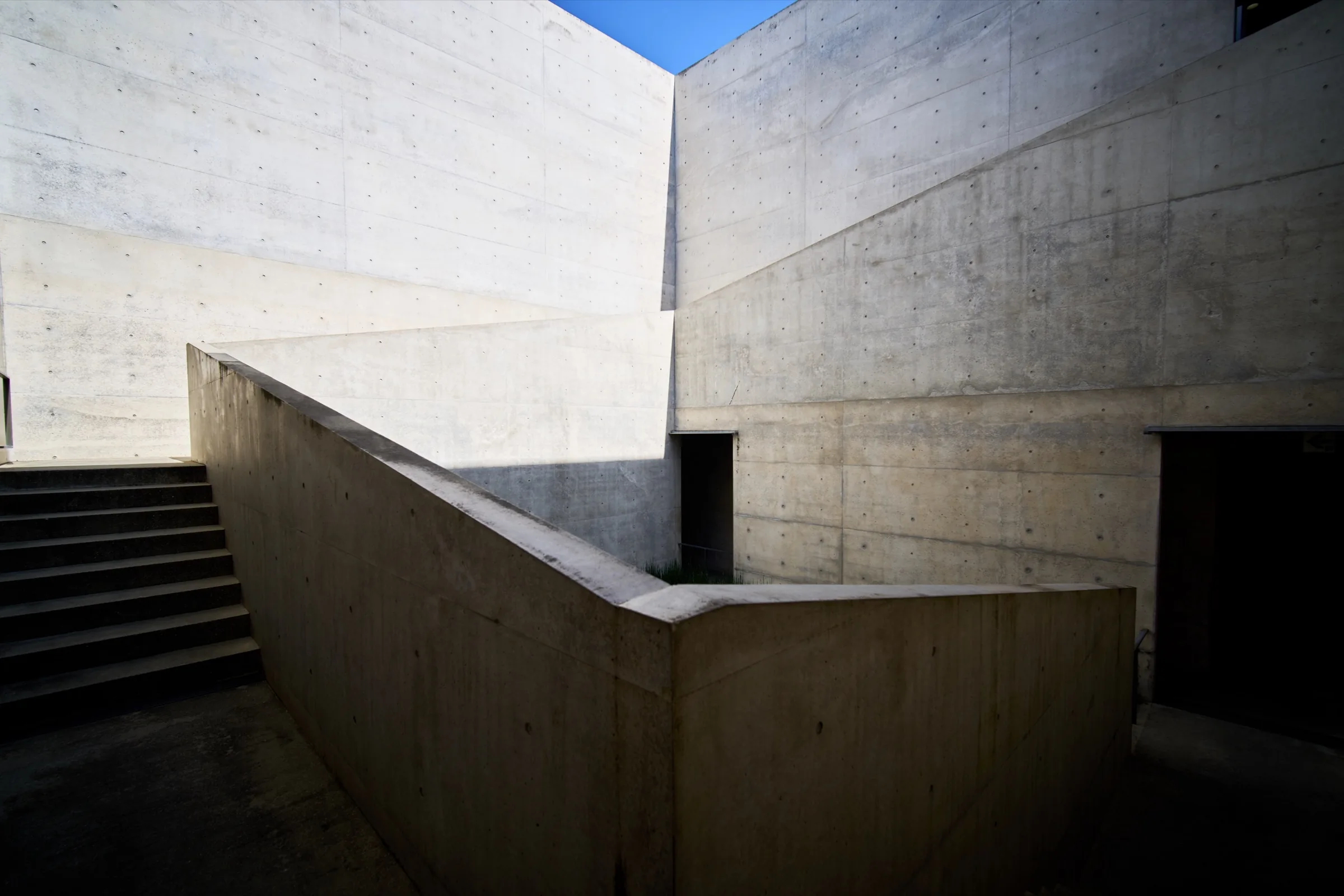 Tadao Ando concrete architecture courtyard with sharp afternoon shadows at Chichu Art Museum on Naoshima