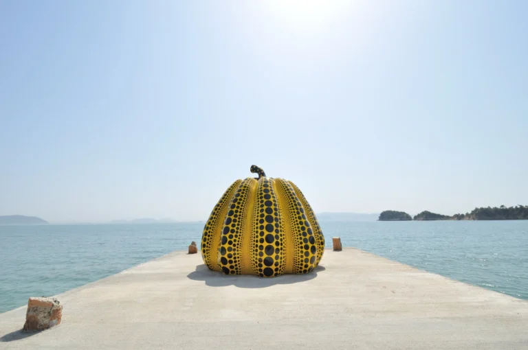 Yayoi Kusama yellow polka-dot pumpkin sculpture on Naoshima pier overlooking the Seto Inland Sea