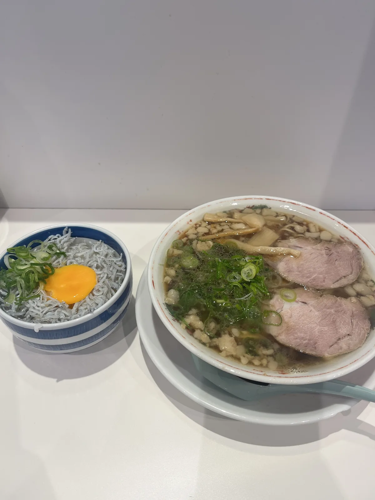 An Onomichi ramen set with a side bowl of shirasu (whitebait) rice topped with raw egg yolk, the signature combination of Setouchi flavours