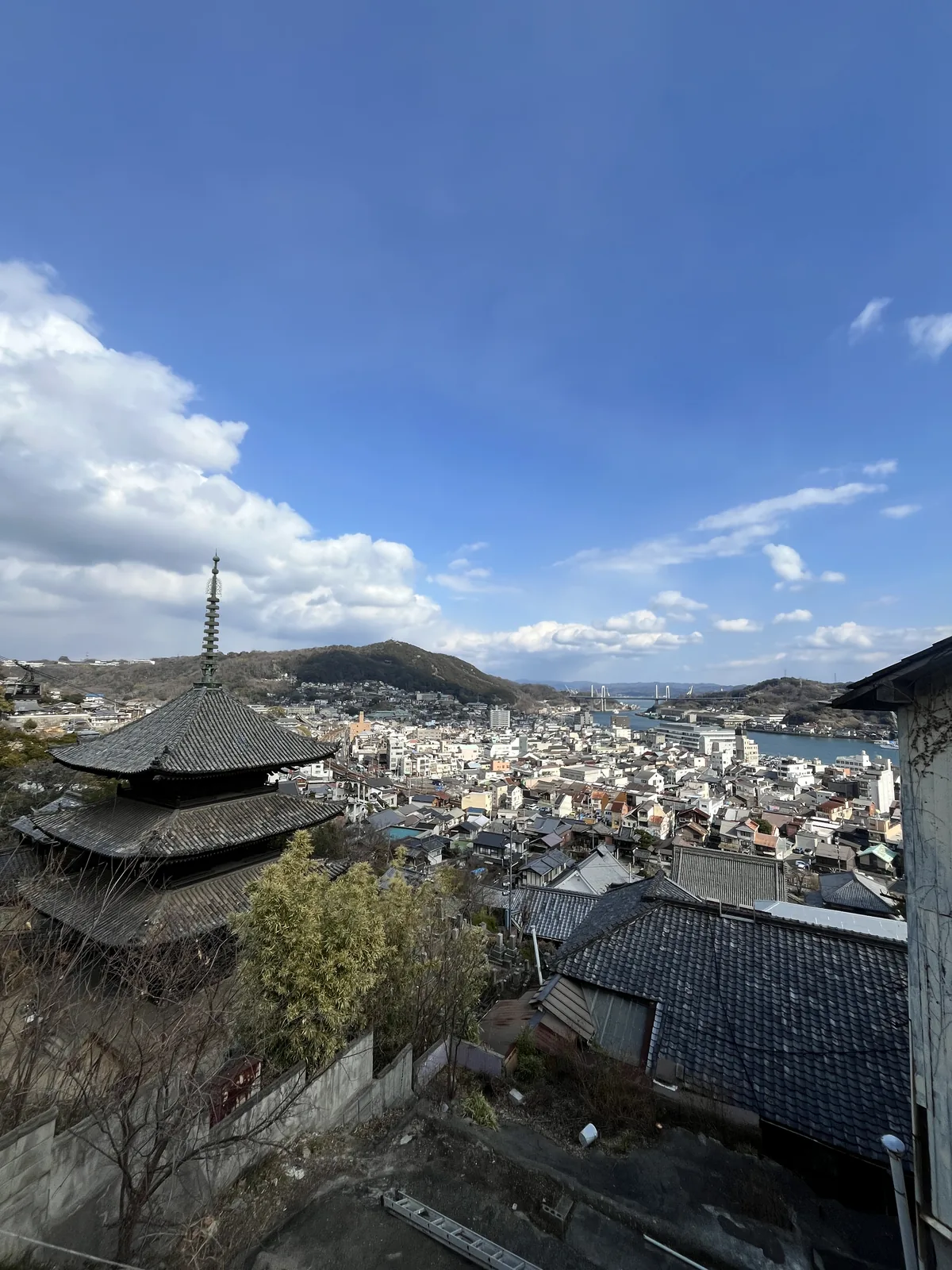 The Tenneiji three-storied pagoda with Onomichi town and the Onomichi Channel spread below in clear blue weather