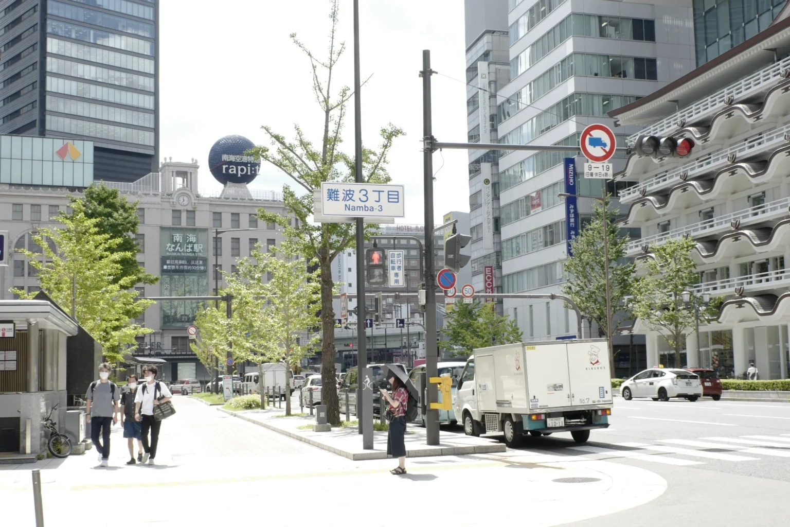 Daytime street scene at Namba 3-chome with Nankai Namba Station signage visible