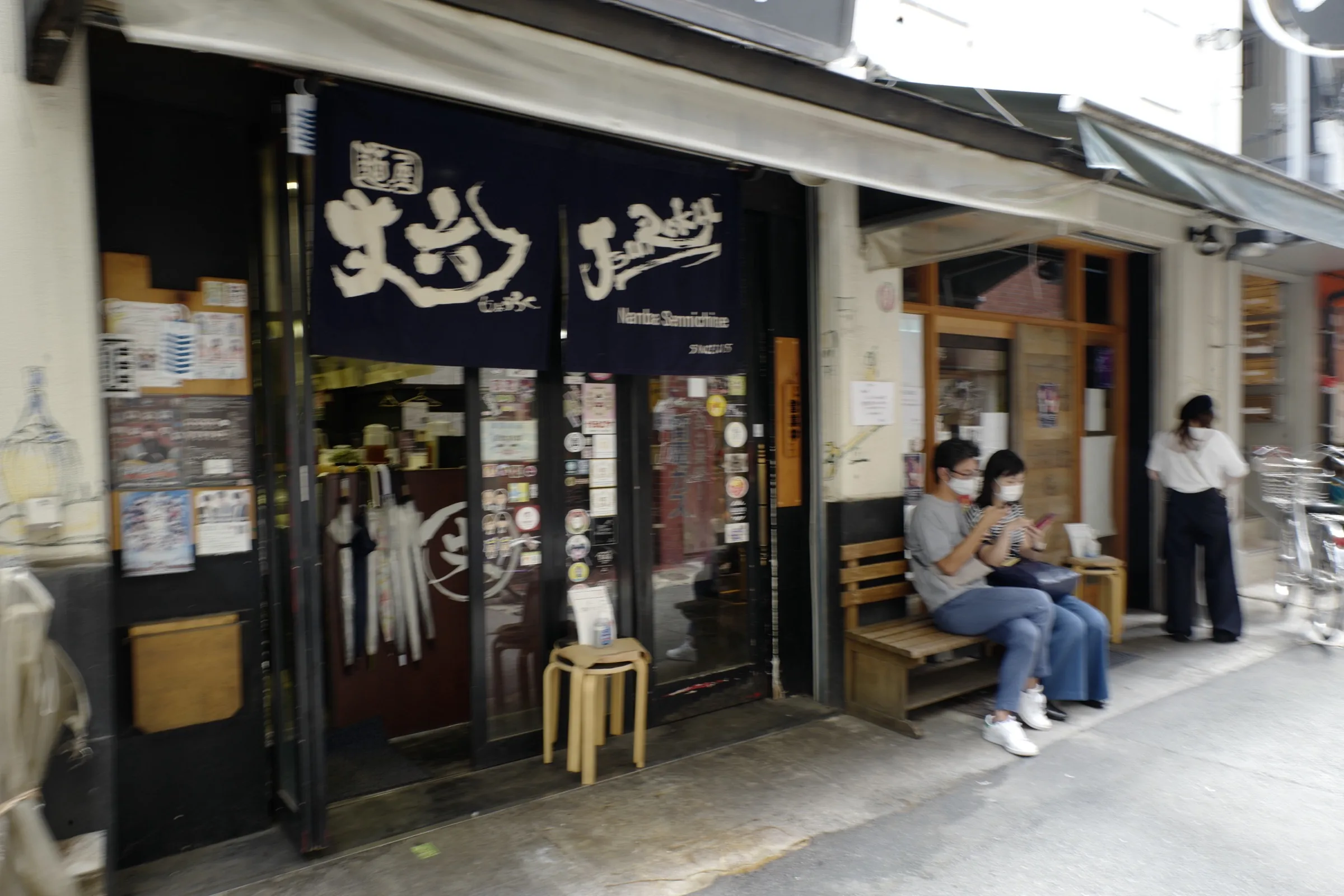 Namba Sennichimae back alley with small izakaya-style shops and noren curtain