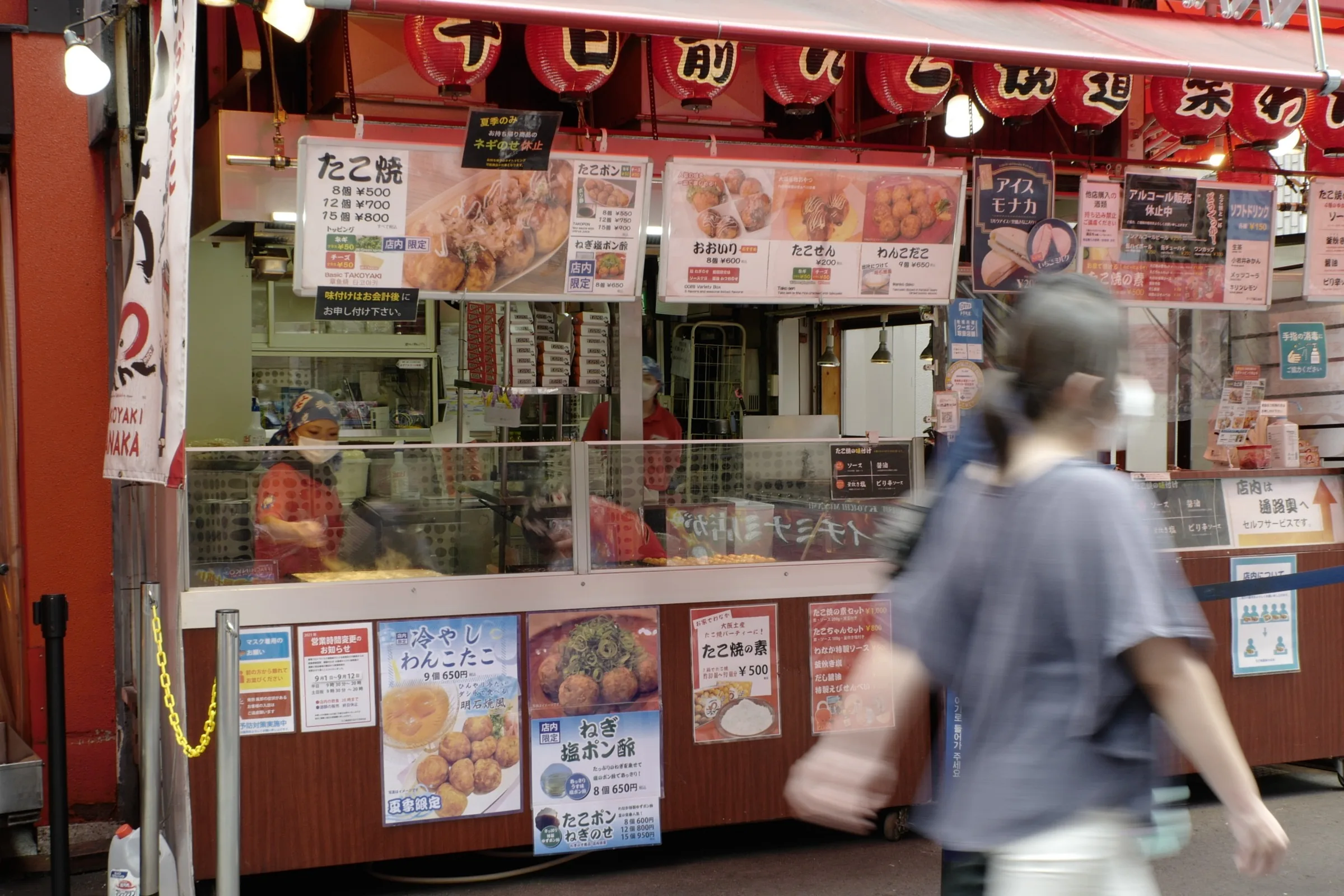 Takoyaki street stall with menu photos and prices in Dotonbori Osaka