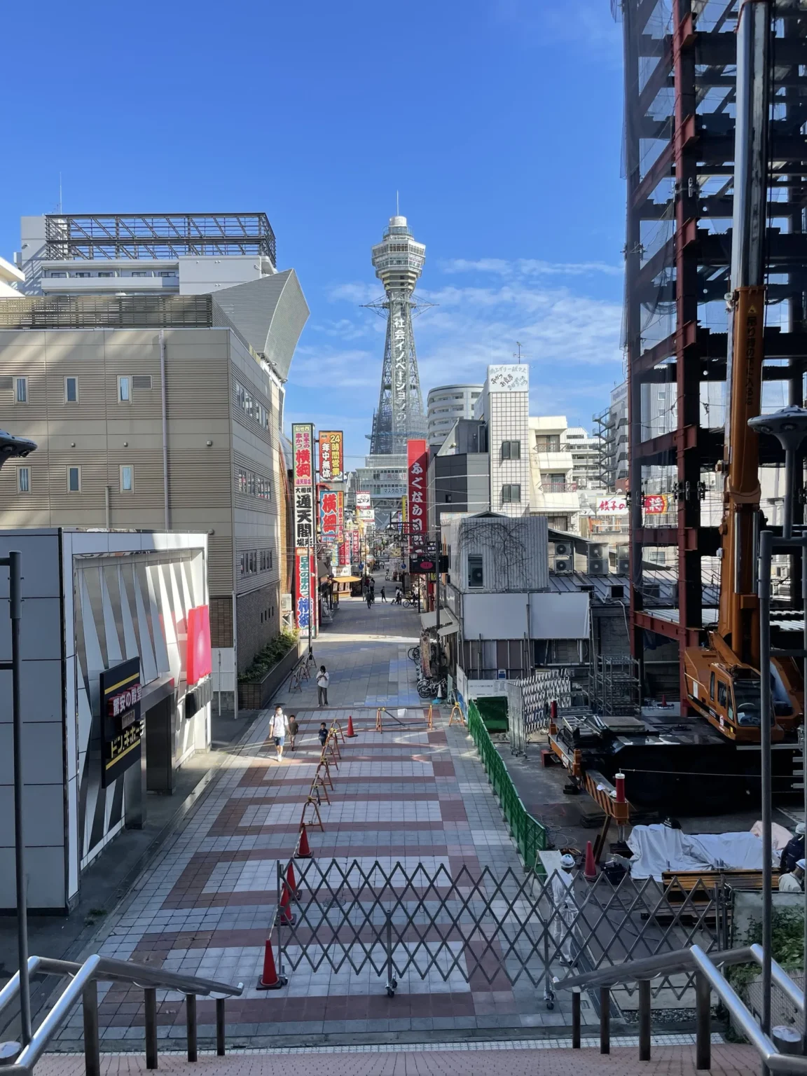 Tsutenkaku tower standing tall at the end of Shinsekai street on a clear day, Osaka