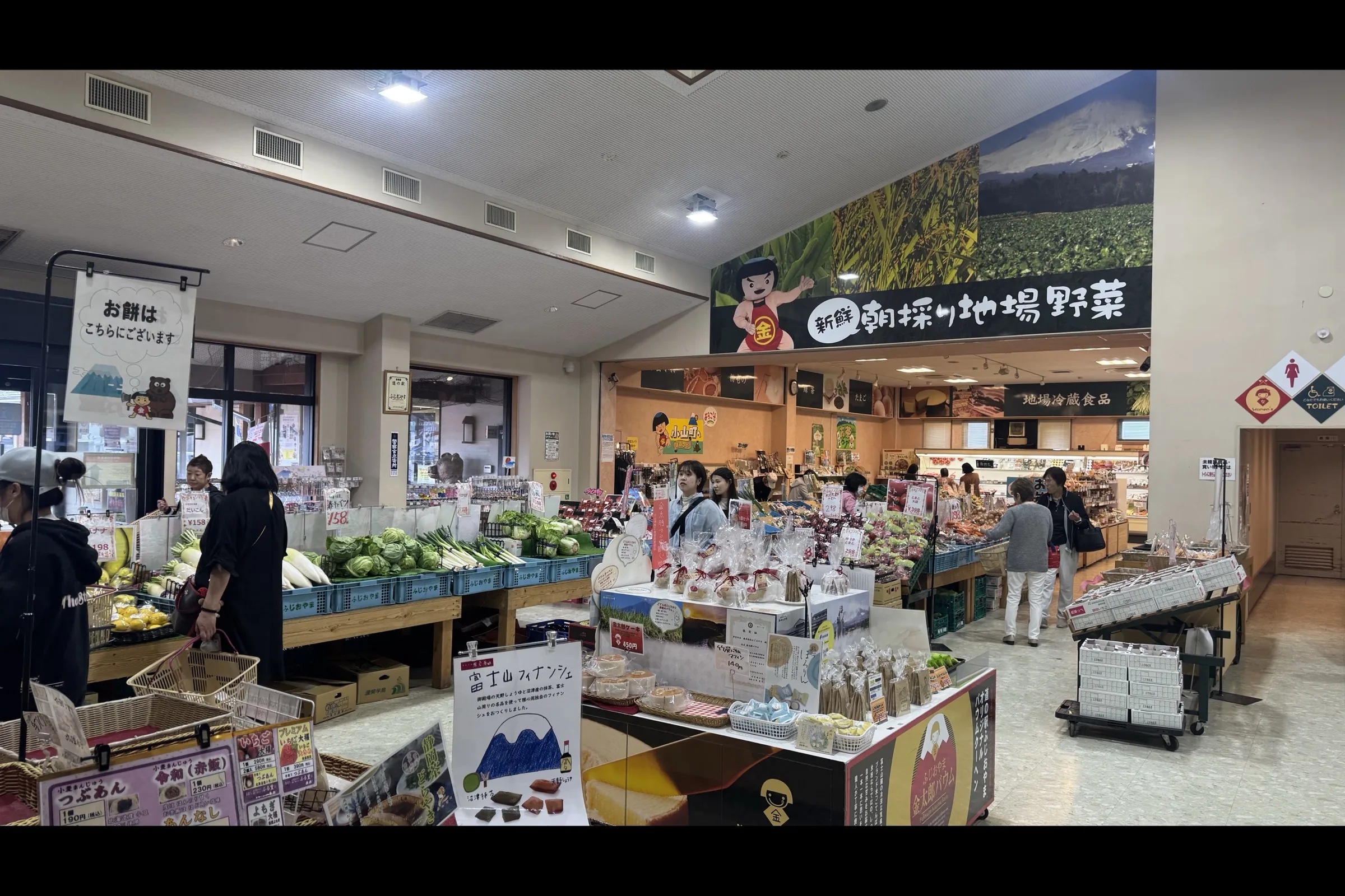 Interior of the local-produce market at Michi-no-Eki Fujioyama with Fuji mural above the back wall