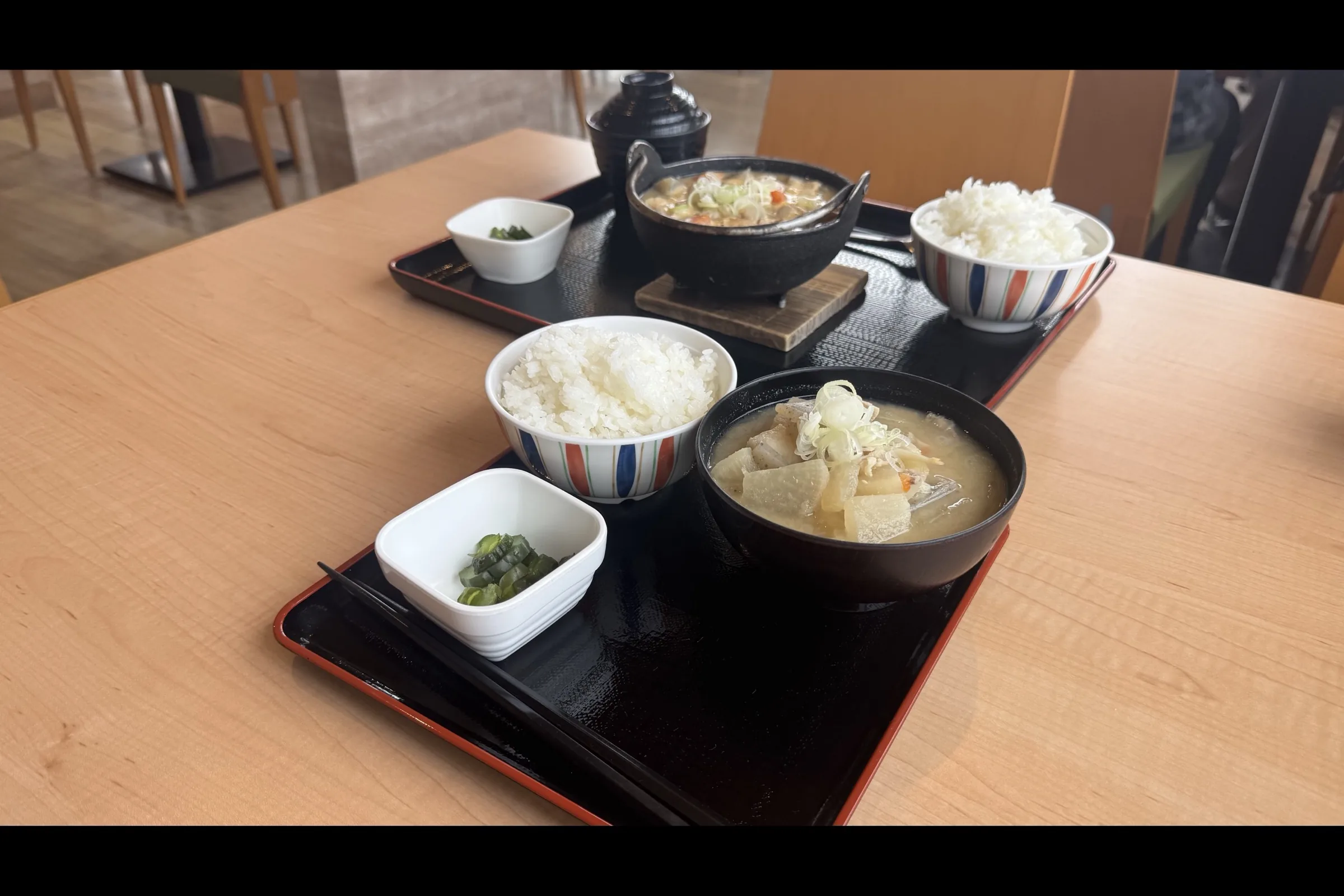 Tonjiru pork miso soup set with rice and pickles on a red lacquer tray