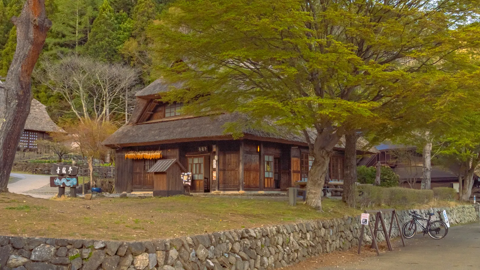 Close-up of a restored thatched-roof house at Saiko Iyashi no Sato Nenba