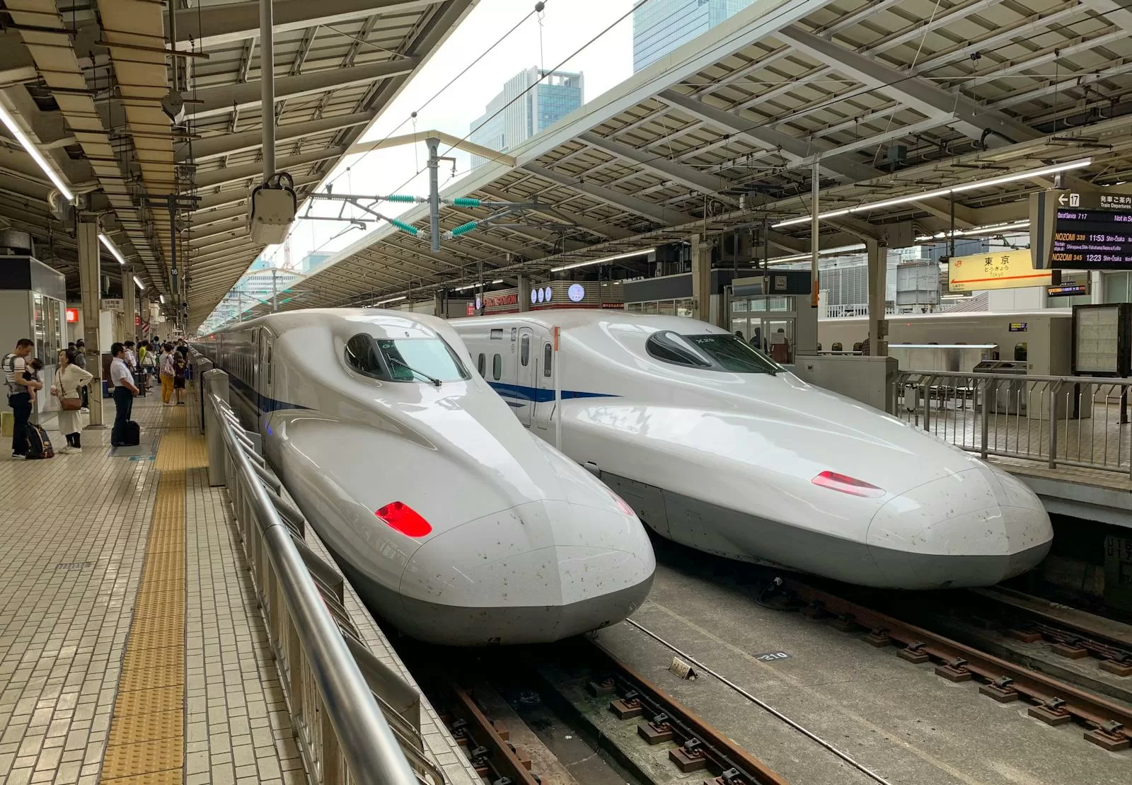 White Shinkansen bullet trains at a Japanese station platform