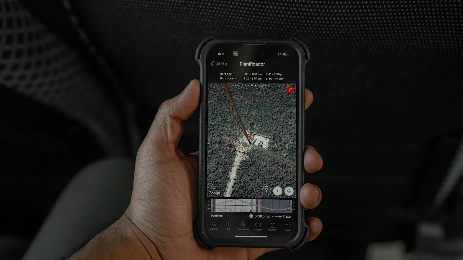 Hand holding a smartphone showing a GPS map and directions