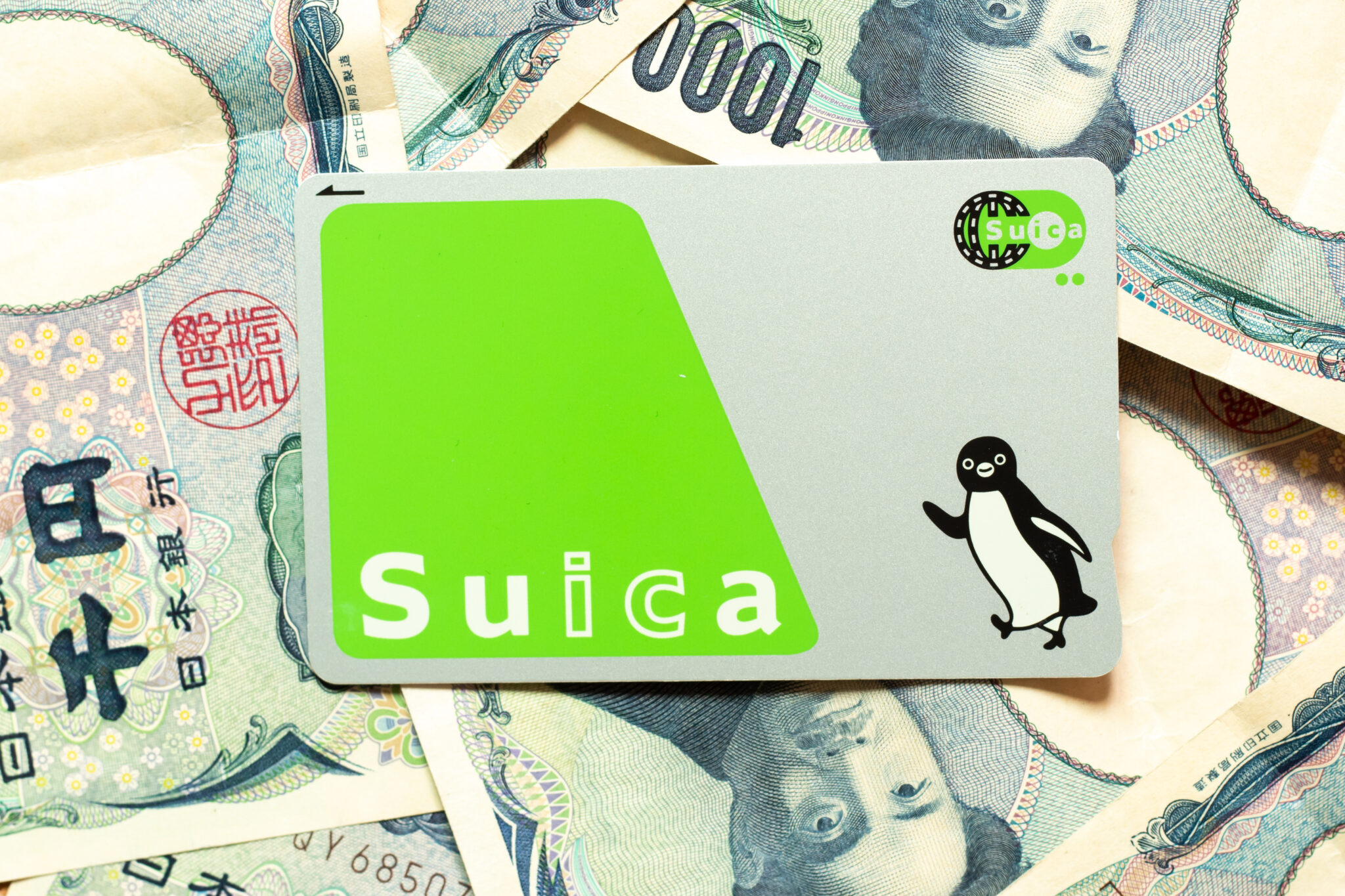 Suica IC card on a spread of Japanese yen banknotes