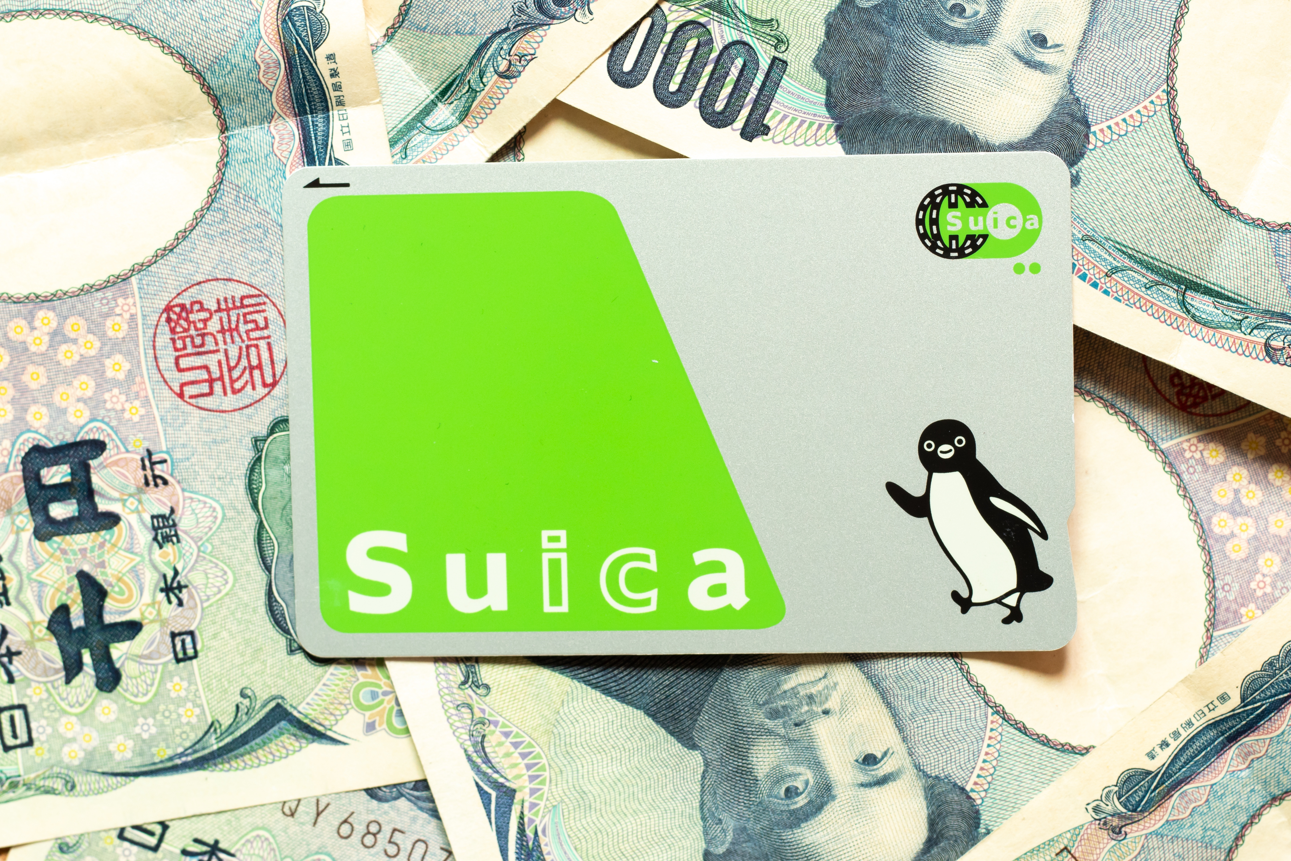 Suica IC card on a spread of Japanese yen banknotes
