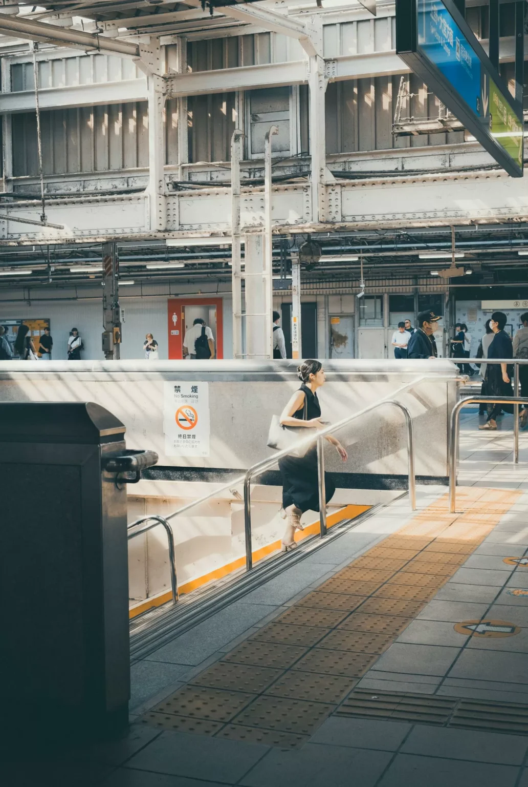 Busy Tokyo train station platform with commuters