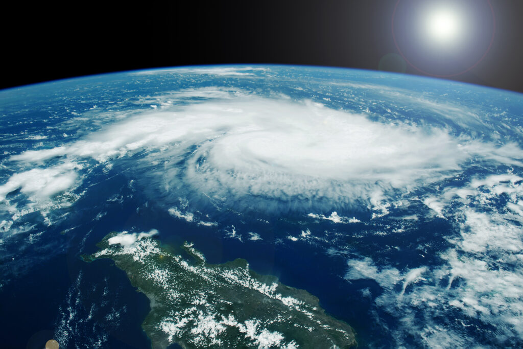 A mature Pacific typhoon photographed from satellite altitude, showing the spiral cloud pattern and central eye over the ocean