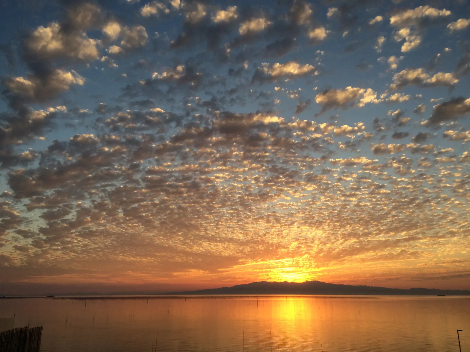 Mt Unzen-Fugen silhouette seen across the Ariake Sea at sunset from Omuta