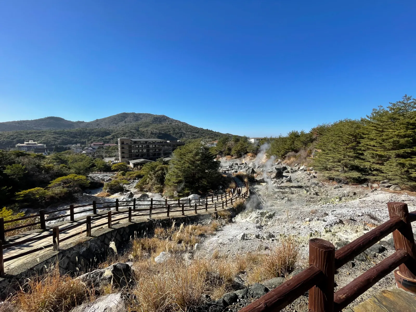 Unzen Jigoku steam vents with onsen hotel buildings in background