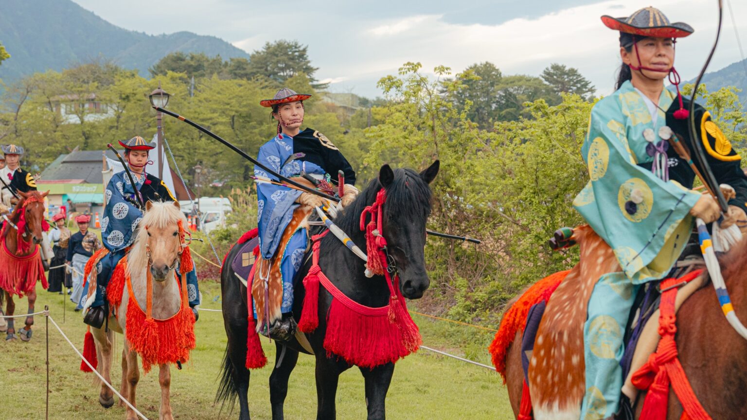 Three yabusame archers in differently colored armor lined up