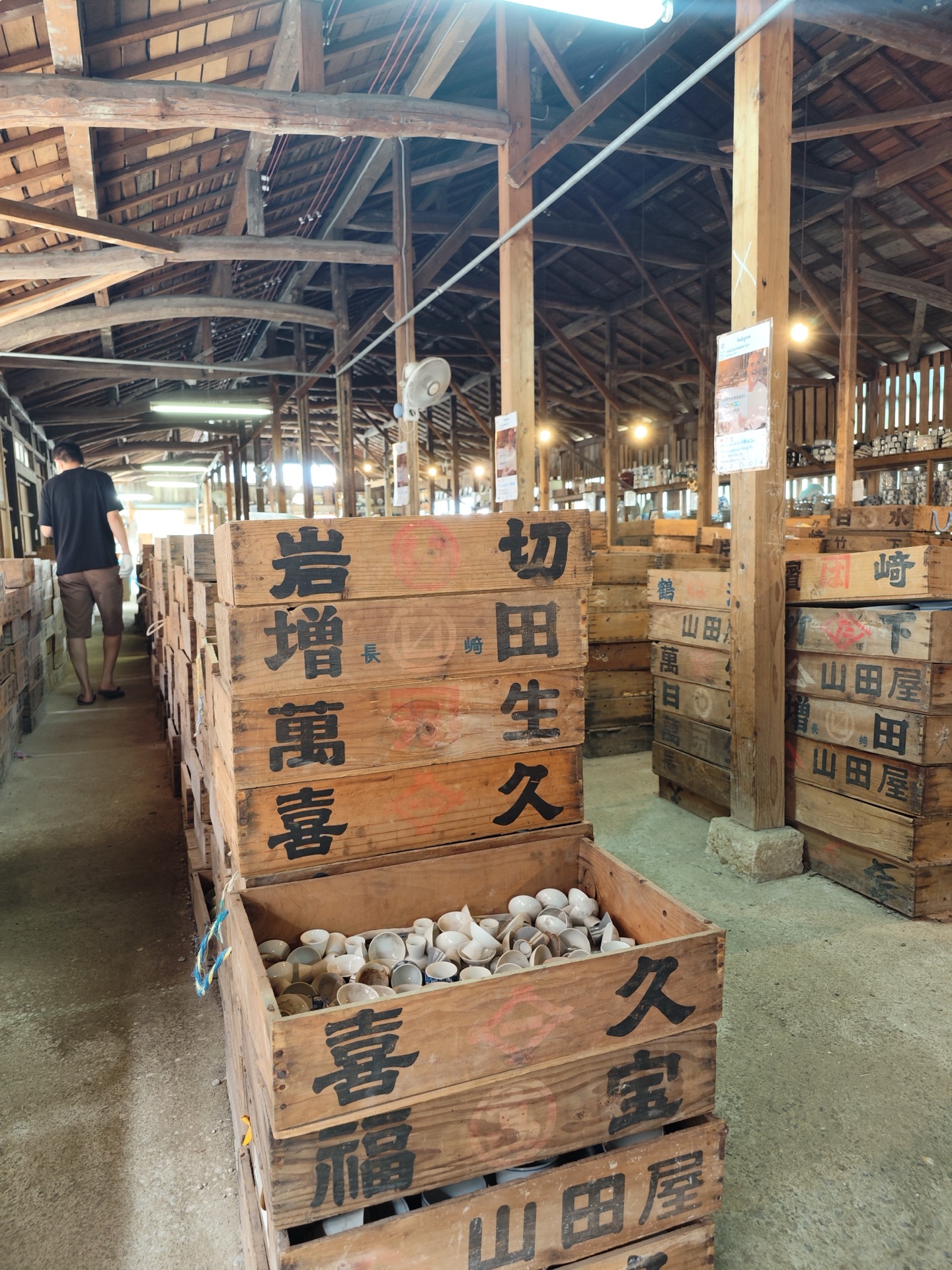 Wooden crates filled with Arita porcelain bowls and dishes at Kouraku-gama