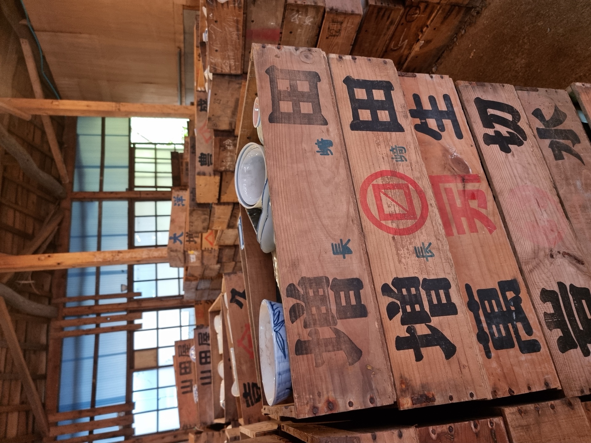 Vintage wooden crate labels with kanji at Kouraku-gama