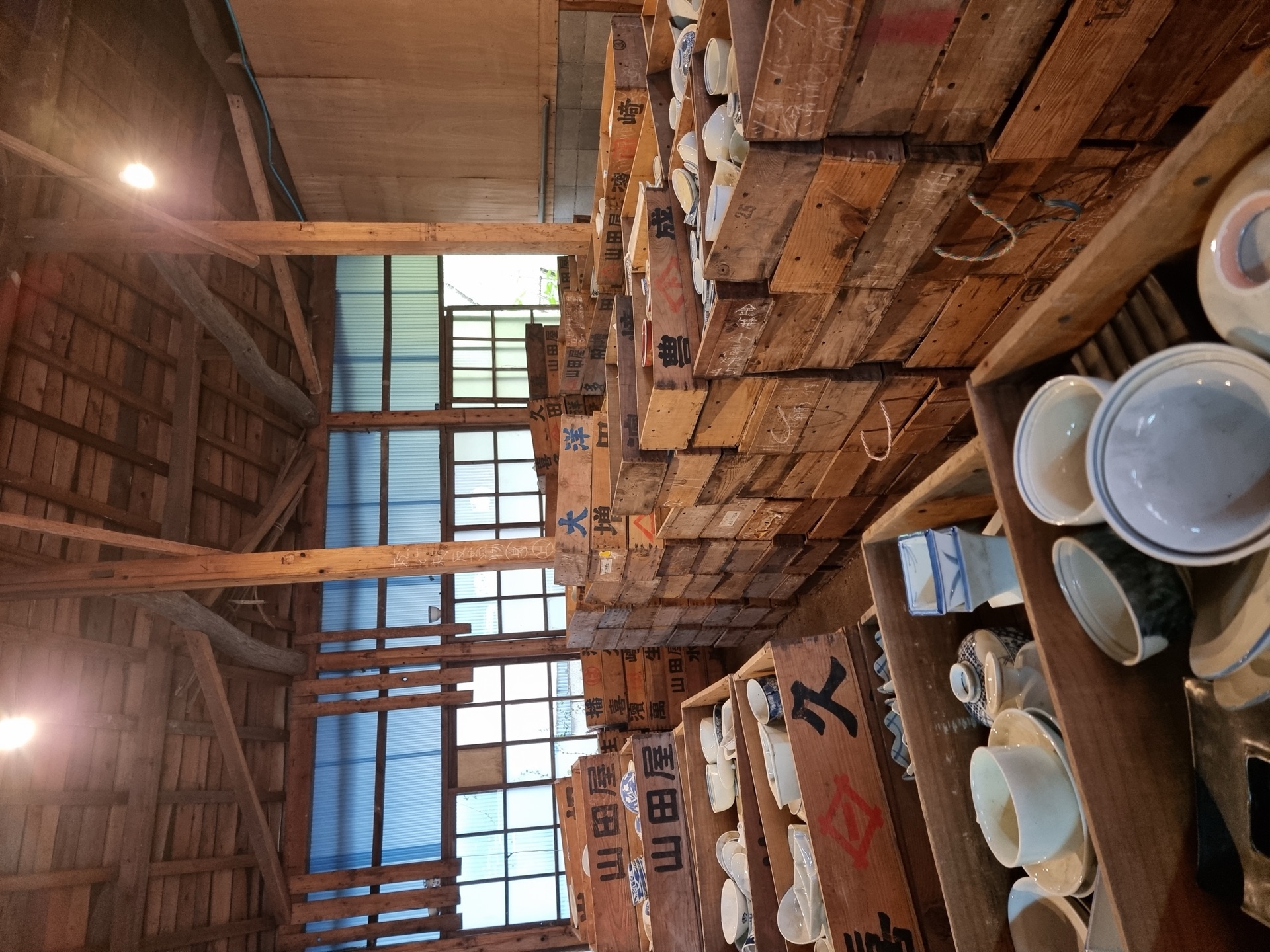 Long corridor of wooden crates at the Kouraku-gama warehouse
