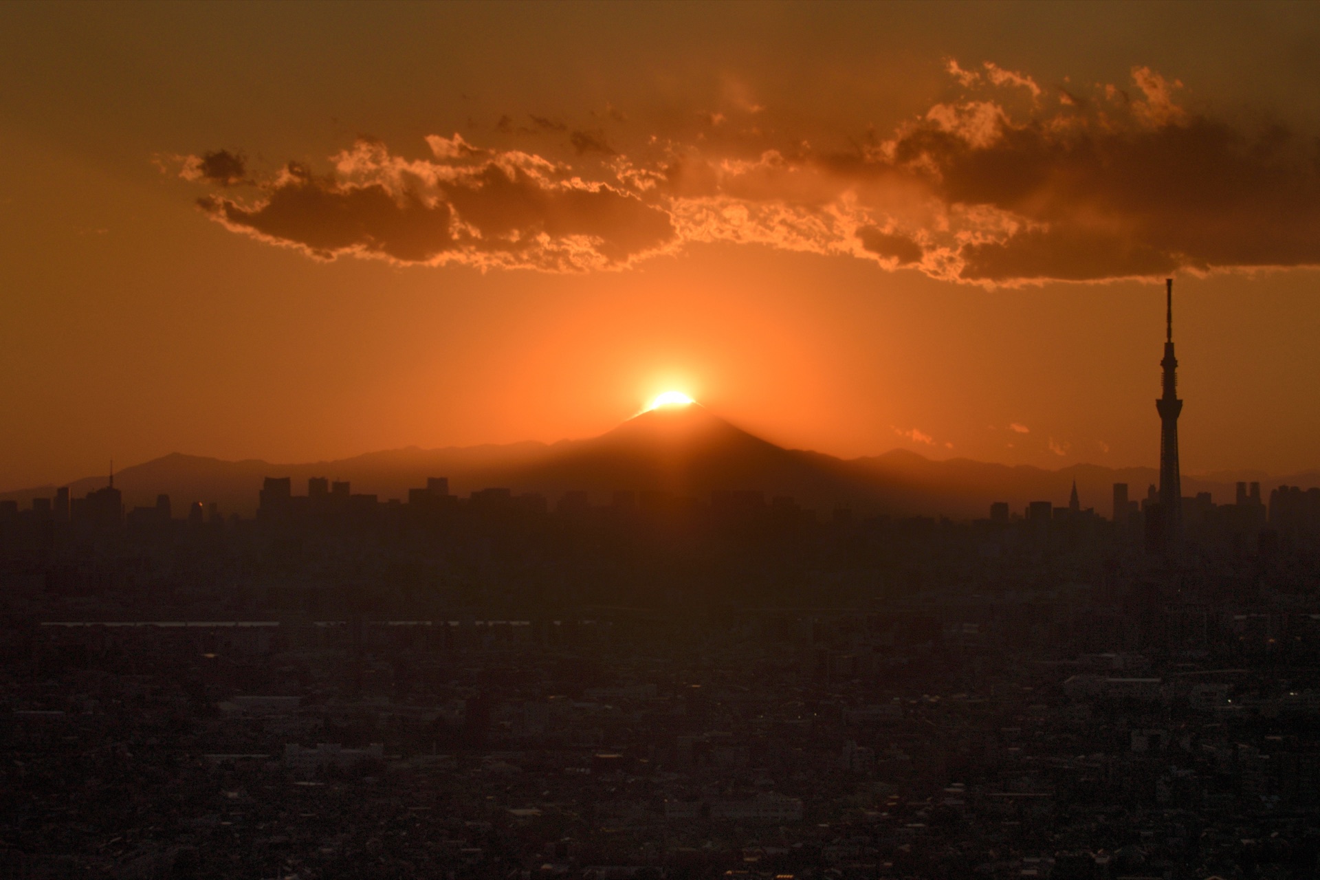 Diamond Fuji from Tokyo with the Tokyo Skytree silhouetted on the right and the city stretched below