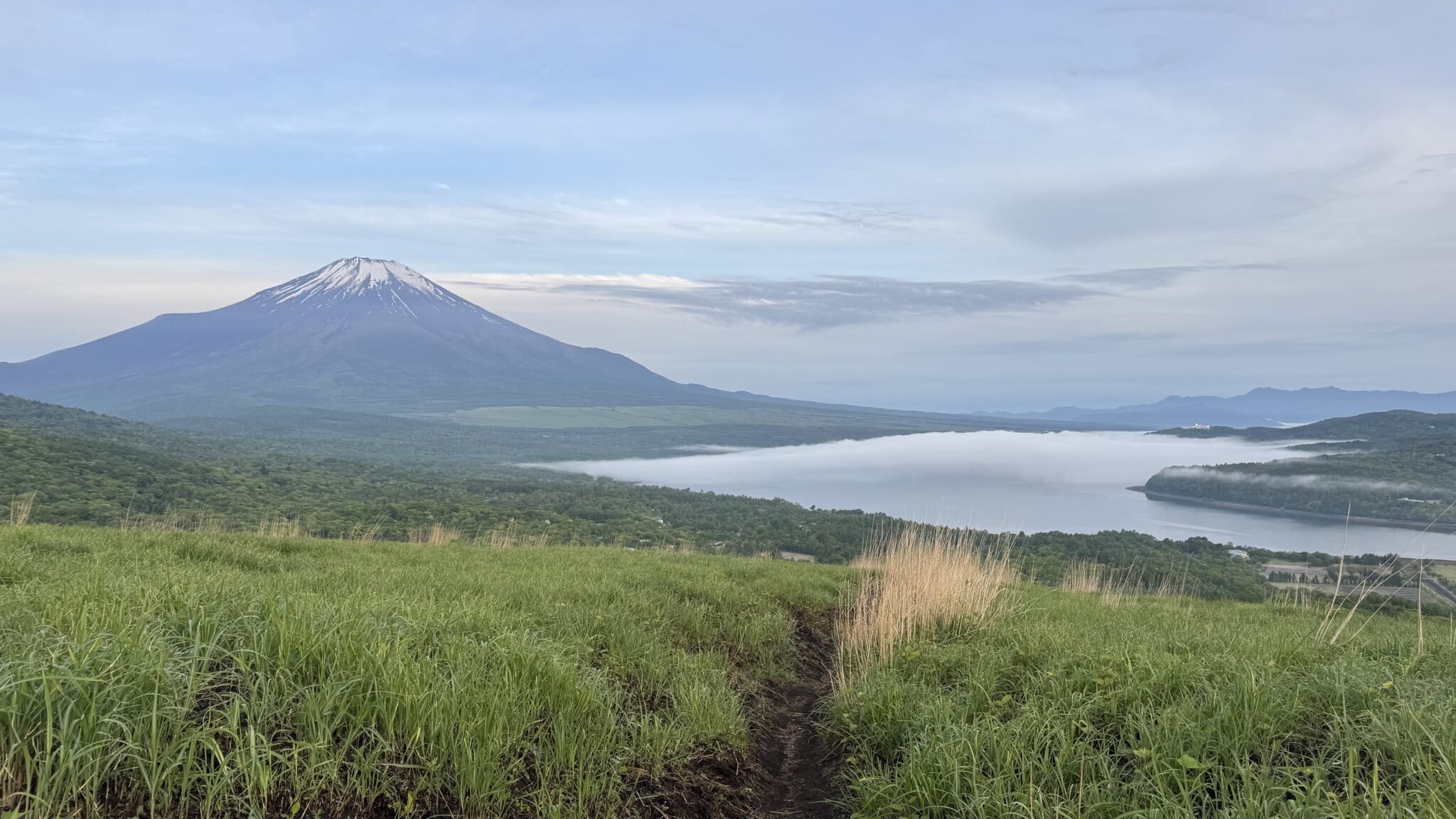 Mt Fuji visible from Lake Yamanaka at 4:54 AM JST on May 26 2026 with dawn mist on the lake