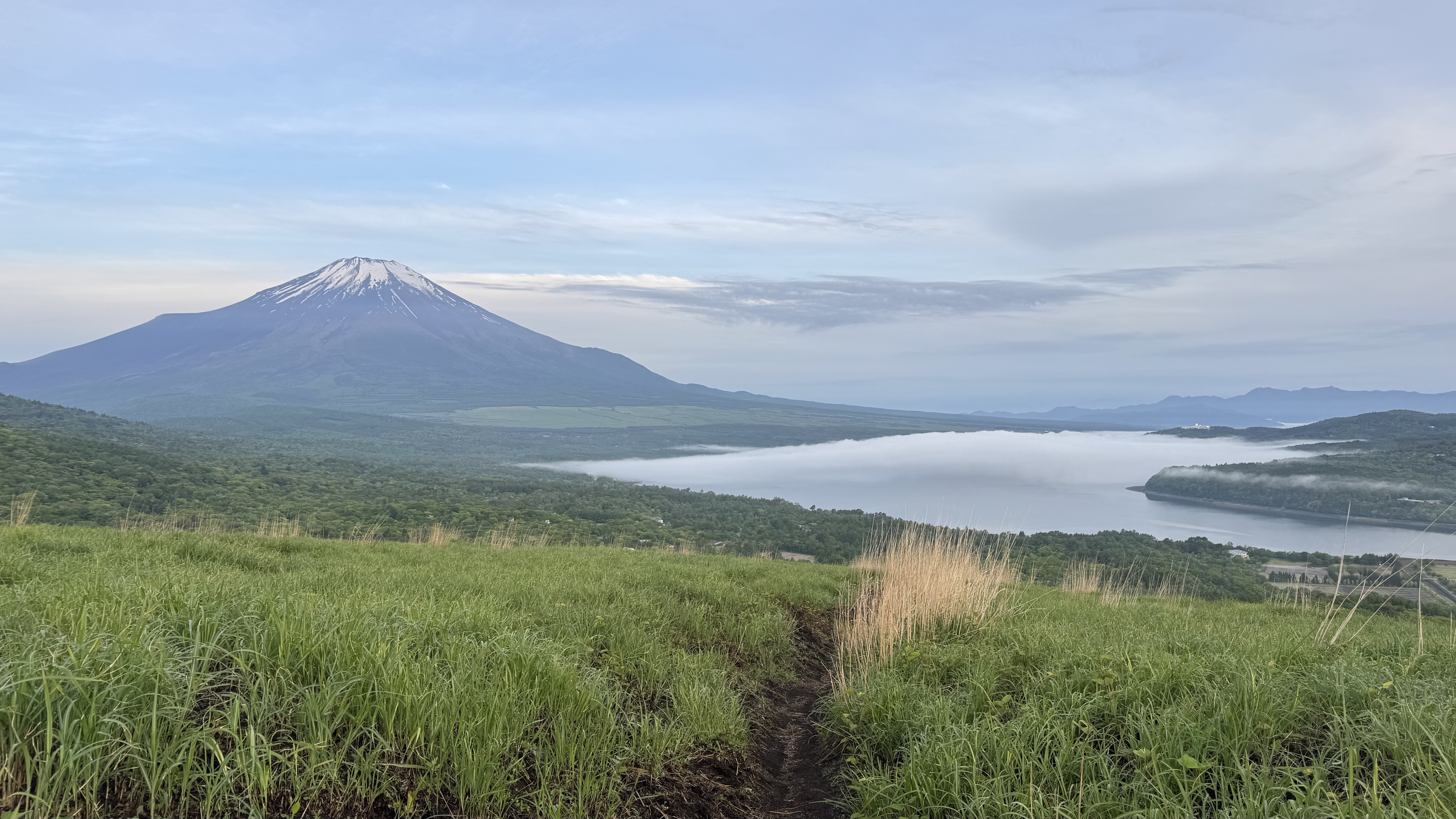 Mt Fuji visible from Lake Yamanaka at 4:54 AM JST on May 26 2026 with dawn mist on the lake