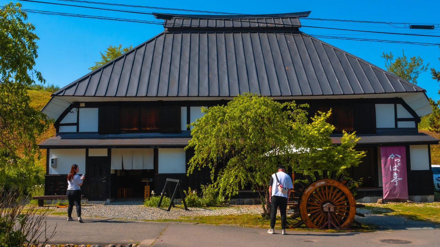 Traditional thatched-roof farmhouse-style restaurant building in Hakuba village