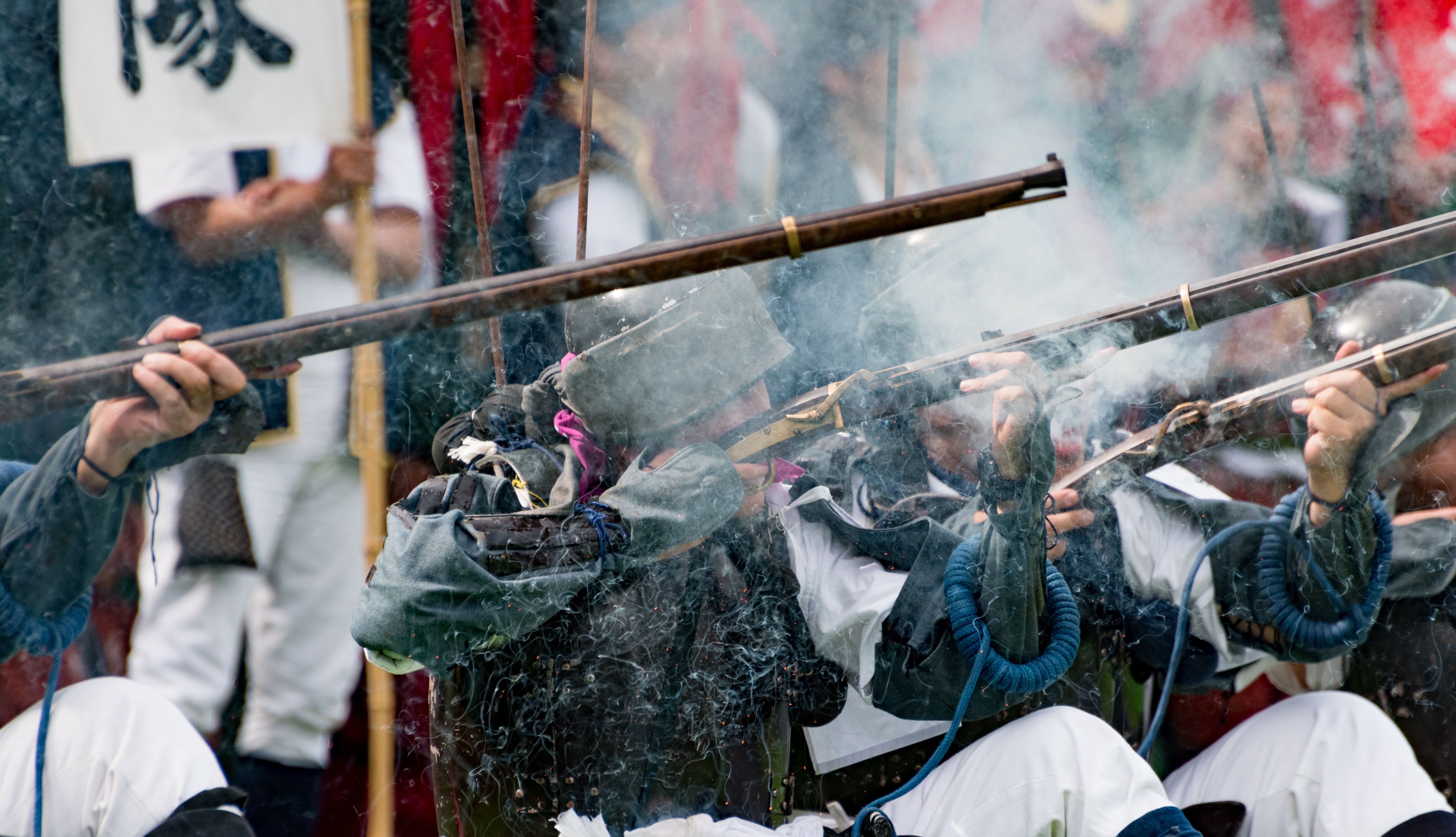 Tanegashima musket reenactment with traditional matchlock firearms in smoke