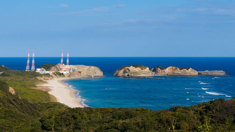 Tanegashima Space Center seen from coastal viewpoint with launch towers