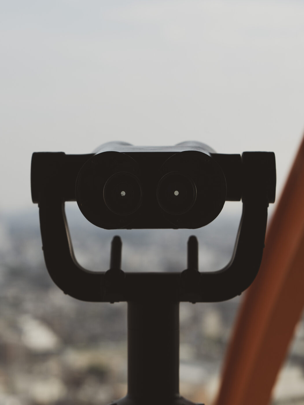 Kyoto Tower observation deck binoculars silhouetted against the Kyoto skyline