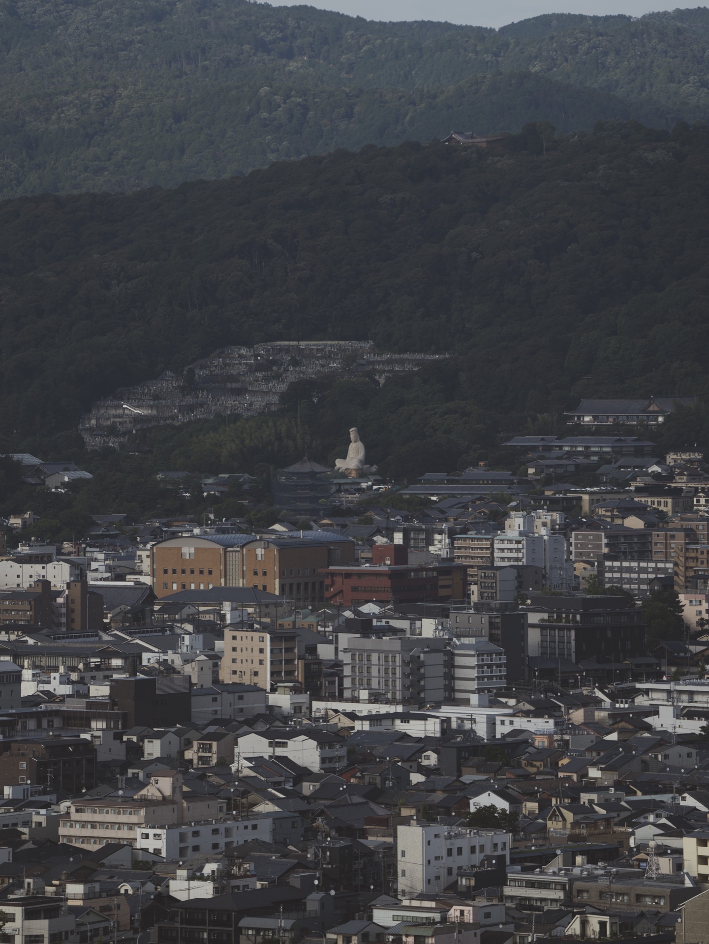 View from Kyoto Tower observation deck looking east toward the Higashiyama mountains and the Daimonji ji character carved into the slope