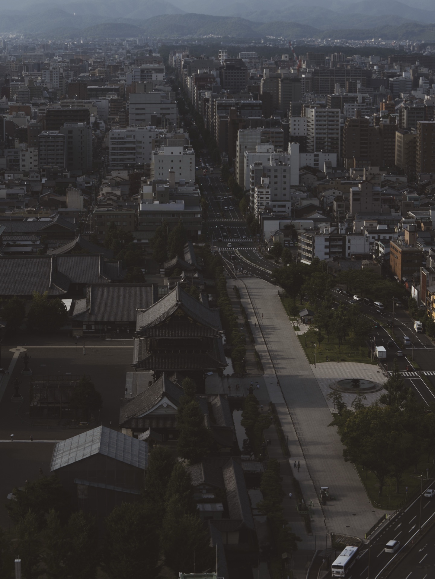 Aerial view from Kyoto Tower looking down at the massive curved roof of Higashi Hongan-ji temple with the city stretching beyond