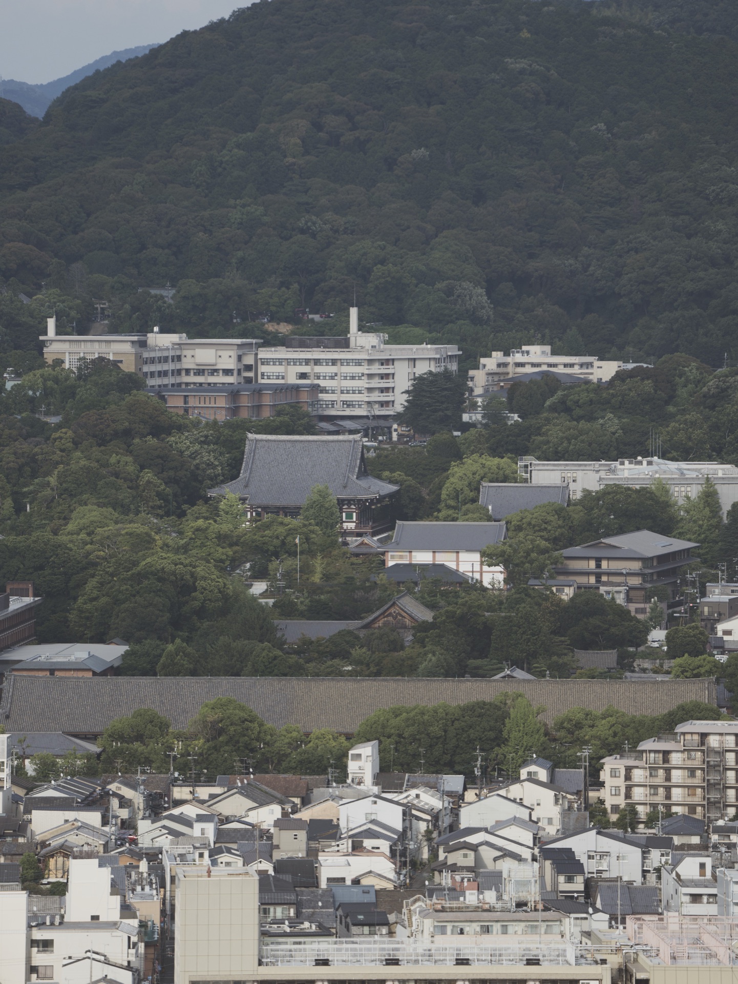 View from Kyoto Tower toward the eastern Higashiyama hills with Kiyomizu-dera area visible in the distance and the city laid out in front