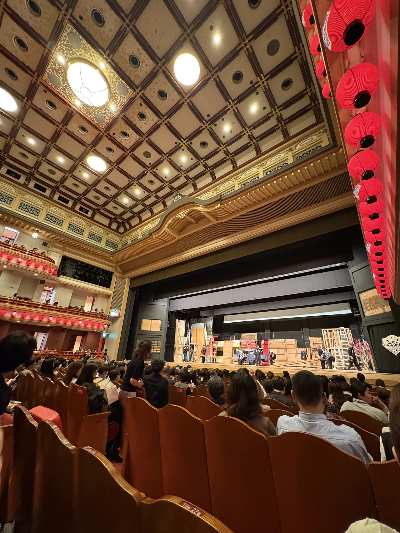 Minamiza auditorium ceiling with rows of red bonbori paper lanterns and coffered ceiling pattern