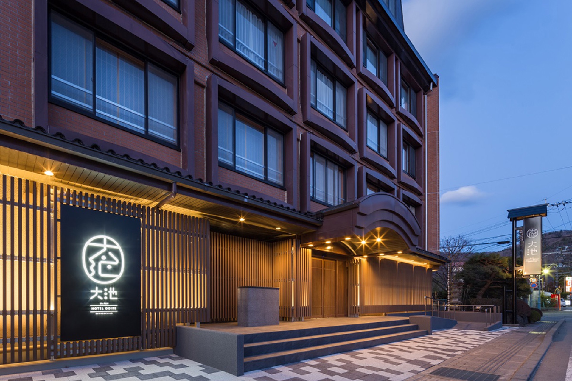 Ooike Hotel exterior entrance at evening with Japanese garden lighting