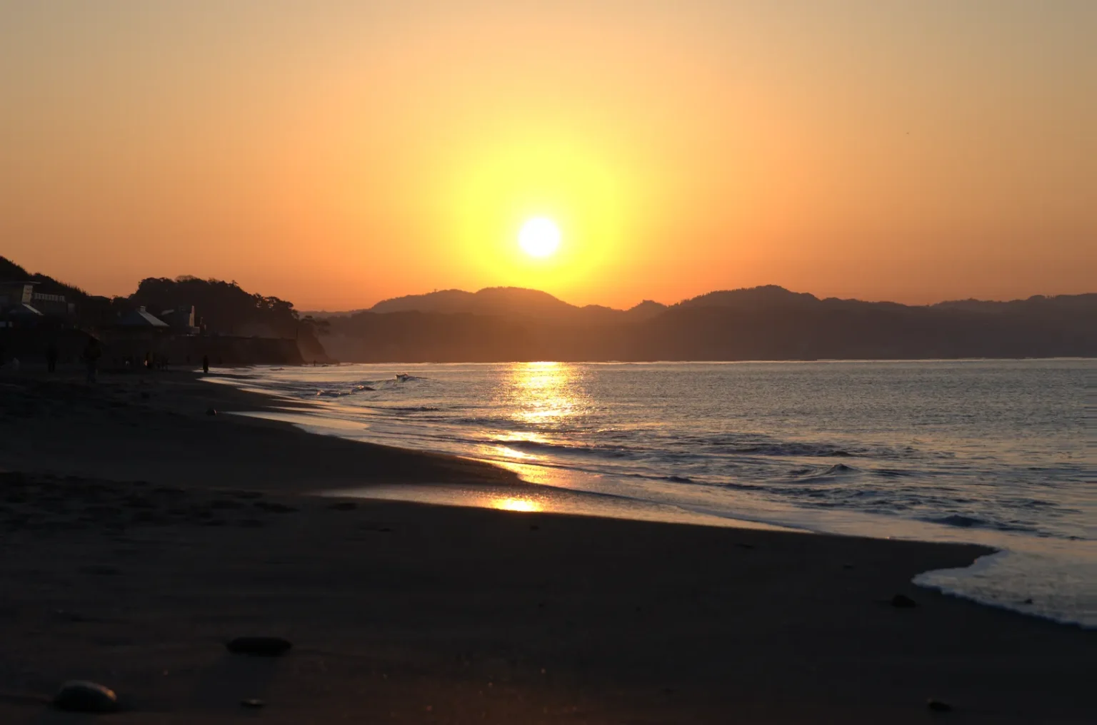 Sunrise on Shichirigahama beach in Shonan with the wet sand reflecting the orange sky