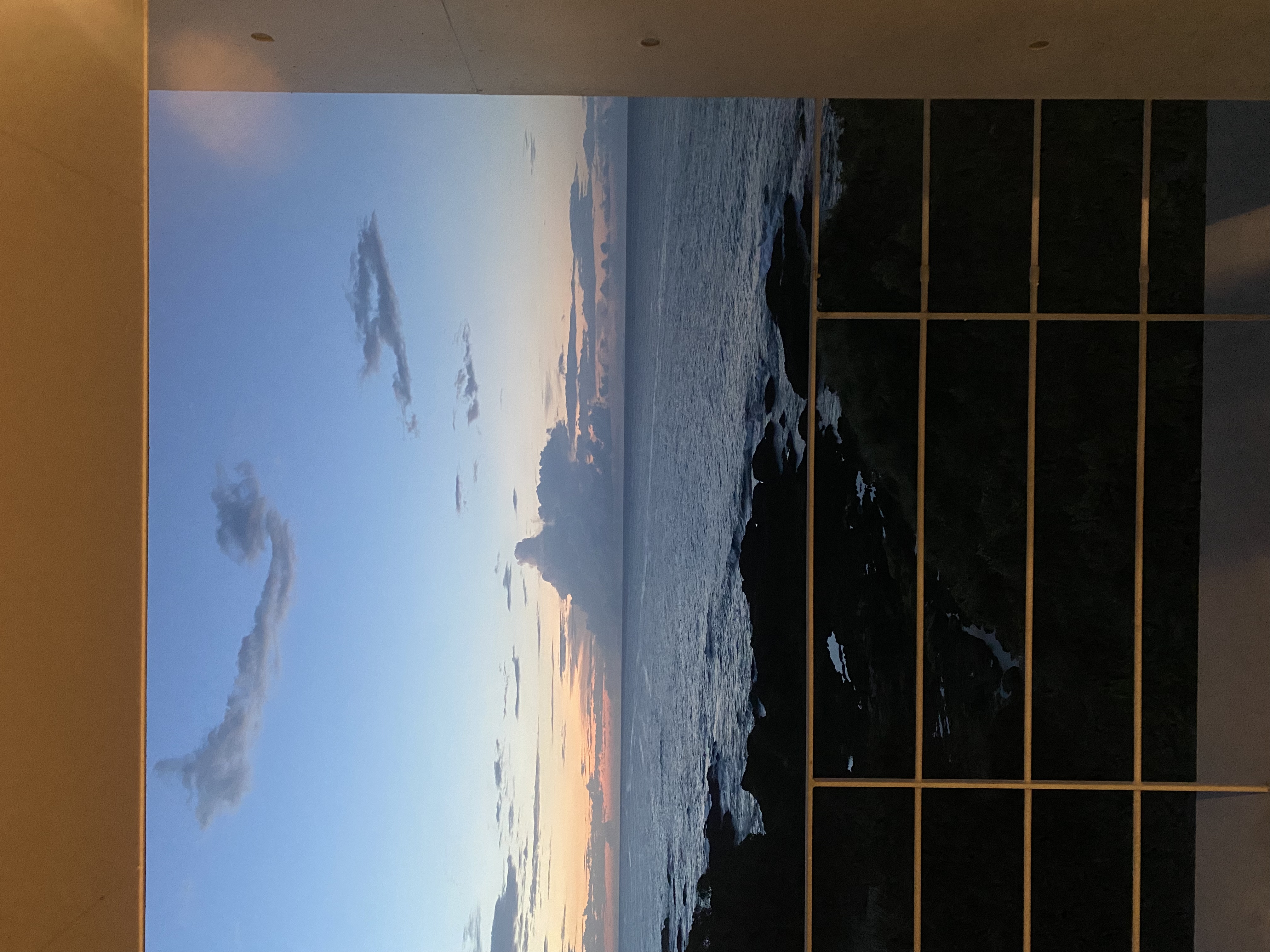 Sea-facing deck view at sunset over the rocky Yakushima north shore