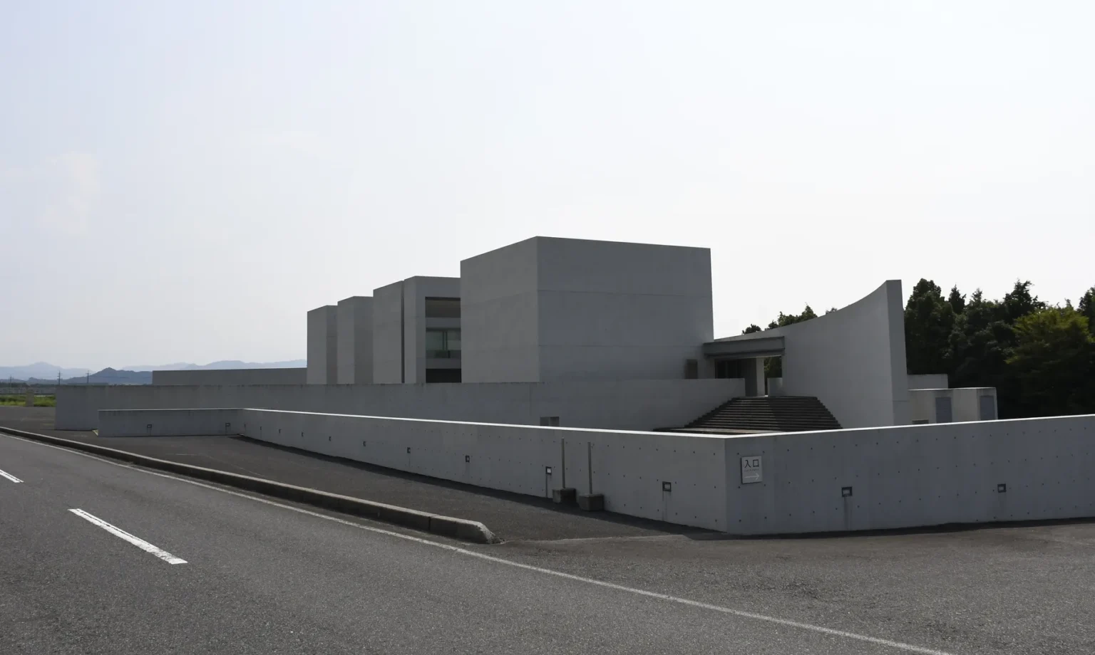 The exterior of Shoji Ueda Museum of Photography in Hoki Tottori showing the four bare concrete cubes designed by Shin Takamatsu against a clear sky