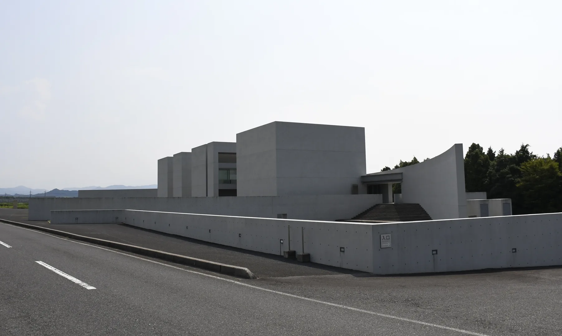 The exterior of Shoji Ueda Museum of Photography in Hoki Tottori showing the four bare concrete cubes designed by Shin Takamatsu against a clear sky