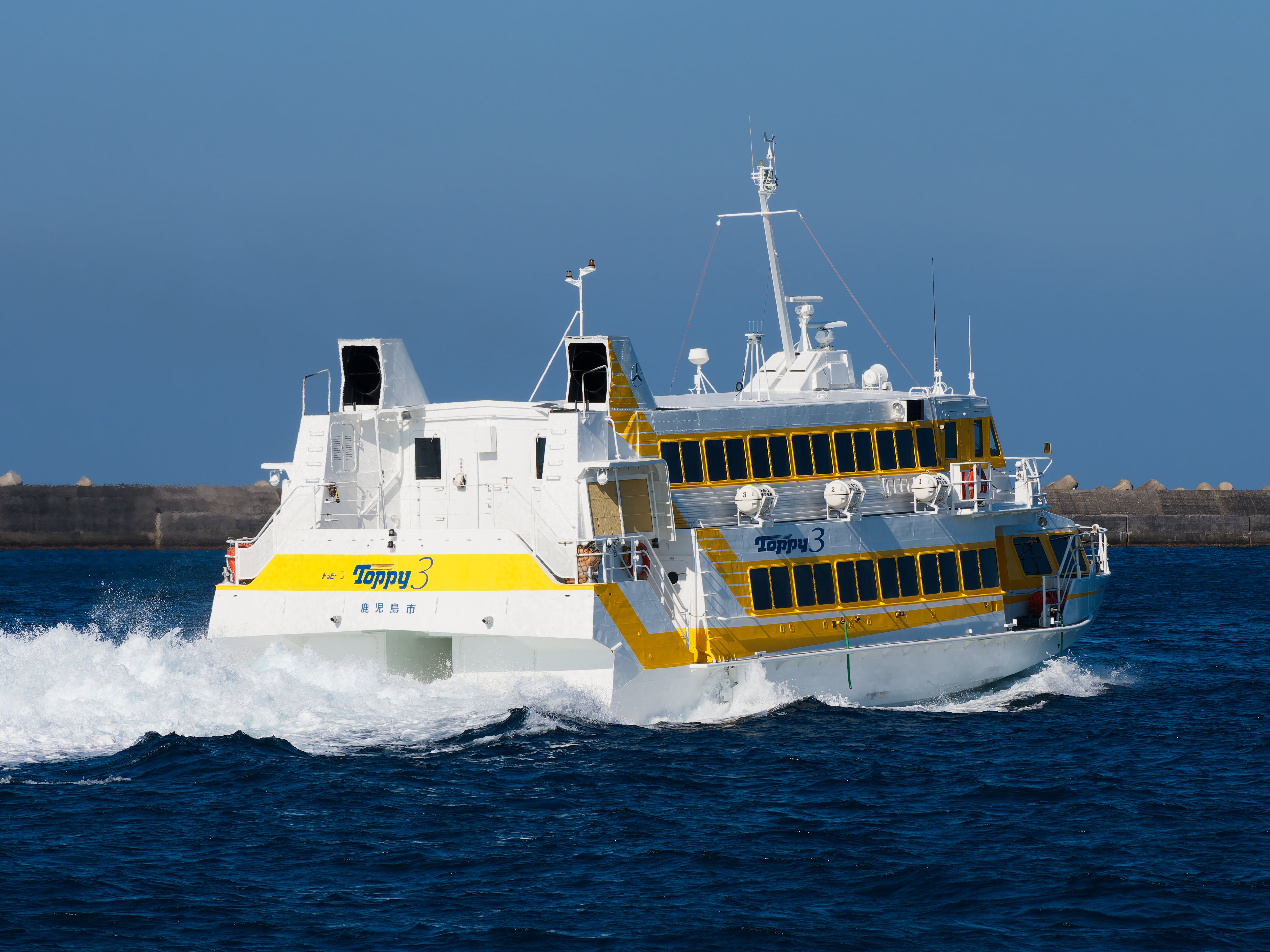 Yellow and white Toppy 3 high-speed hydrofoil bound for Yakushima from Kagoshima