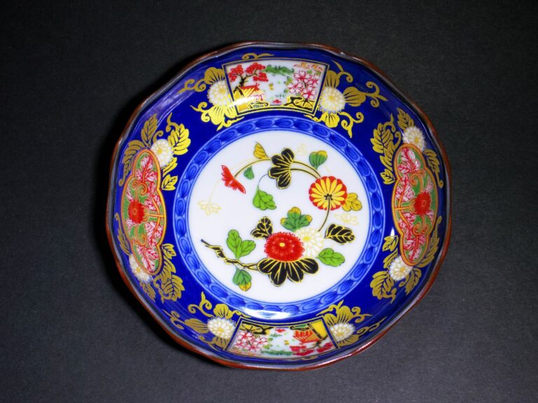 An antique Old Imari (Ko-Imari) porcelain bowl decorated in deep cobalt blue, iron red and gold brocade with chrysanthemum and flower patterns, the classic Hizen export style made in Arita, Saga