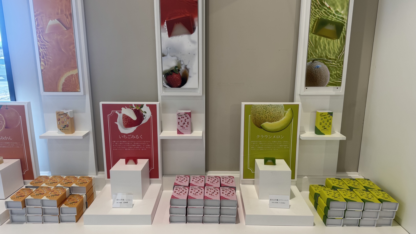 A display of pink and green packaged local sweets and souvenirs at the Asama Market, Tabi-no-Eki Kawaguchiko Base.