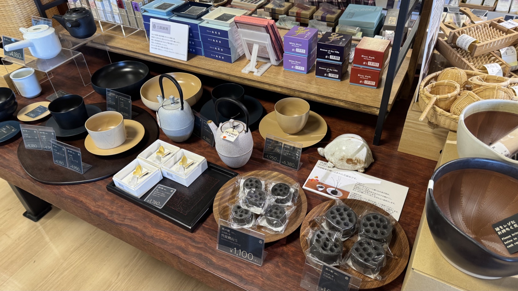 Wooden bowls and ceramic tableware displayed on shelves at the Asama Market, Tabi-no-Eki Kawaguchiko Base.
