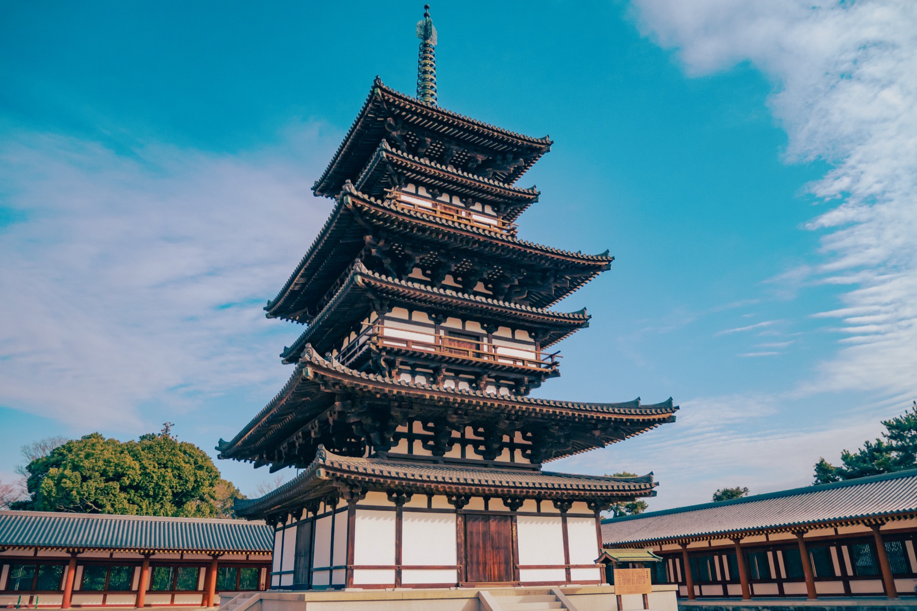 A three-story pagoda at Yakushiji Temple in Nara whose mokoshi skirt-roofs make it appear six-tiered, standing against a blue sky; the East Pagoda is the temple only surviving original building.