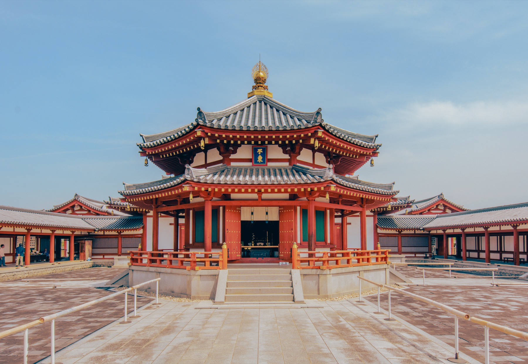 The octagonal Genjo-Sanzoin hall at Yakushiji Temple in Nara, a red and white building with a golden finial that enshrines remains of the monk Xuanzang and Hirayama Ikuo Silk Road murals.