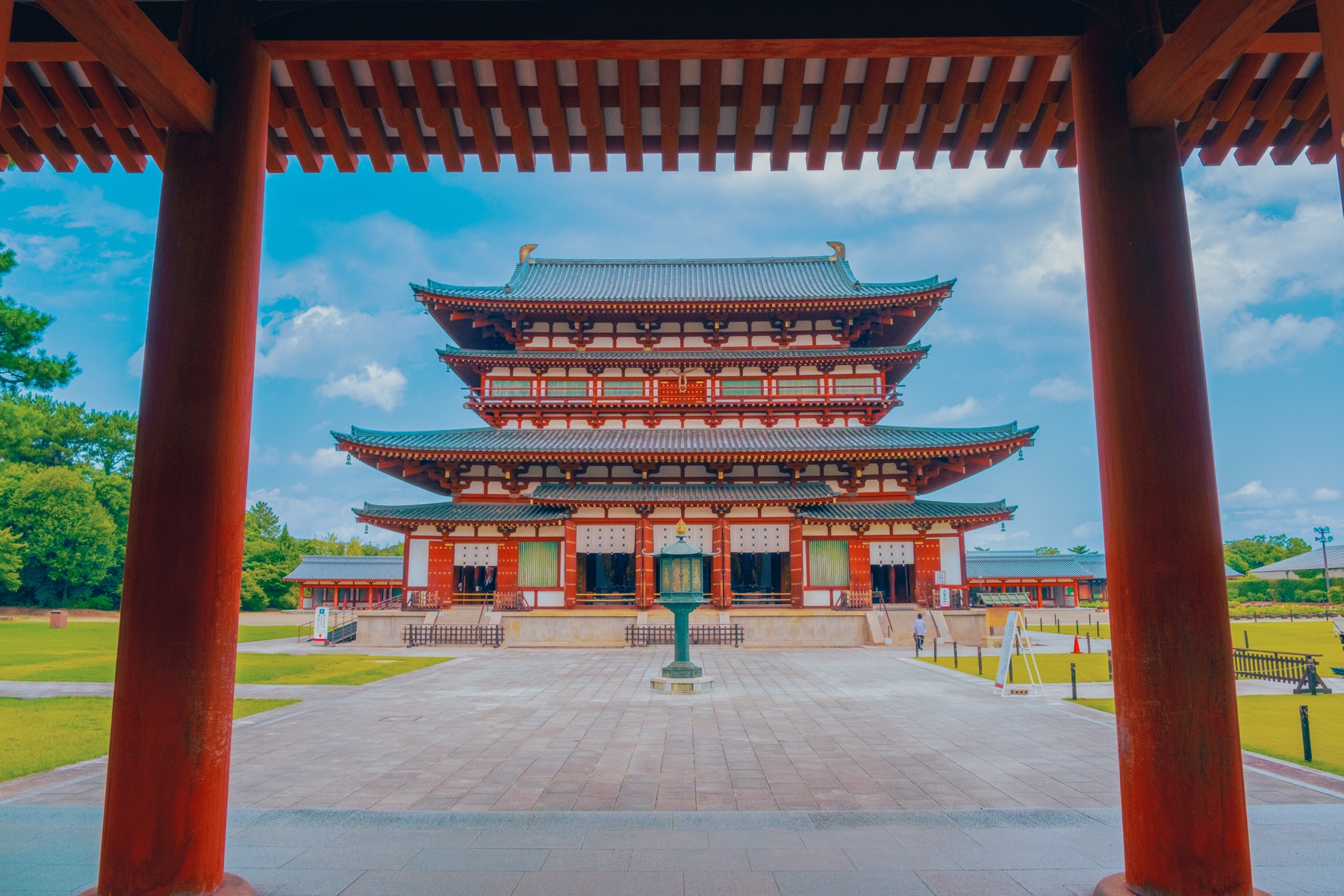 The vermilion and white Golden Hall of Yakushiji Temple in Nara seen head-on through the corridor gate, the main hall that houses the National Treasure bronze Yakushi Triad.