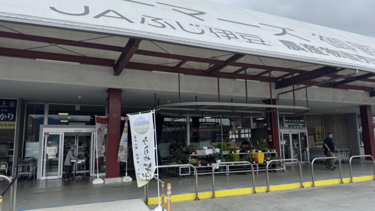 The entrance of the JA Fuji-Izu Farmers Gotemba farm-stand market with its wide canopy, potted flowers and shopping carts in Gumizawa, Gotemba, Shizuoka