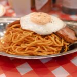 Classic Japanese napolitan topped with a fried egg at Pancho Kichijoji