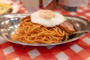 Classic Japanese napolitan topped with a fried egg at Pancho Kichijoji